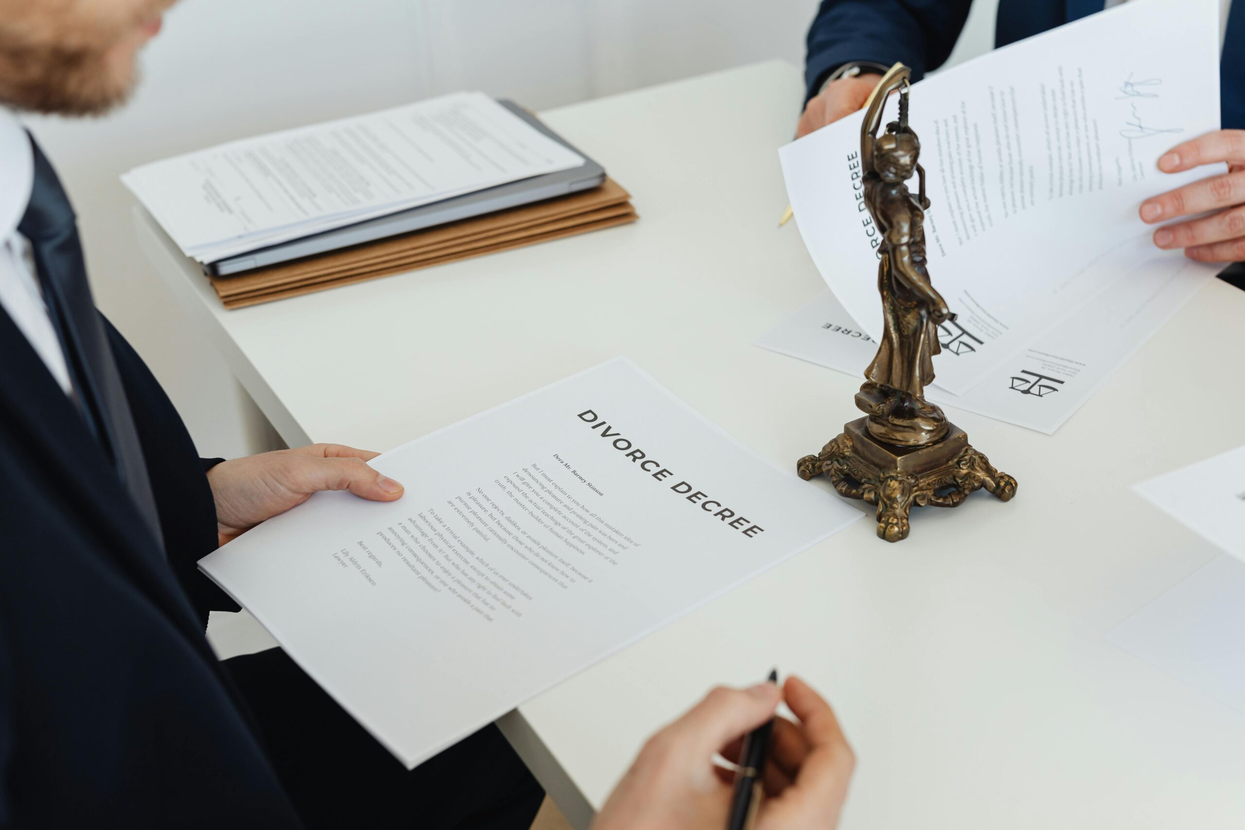 A person looking stressed while reviewing legal documents on defamation risks