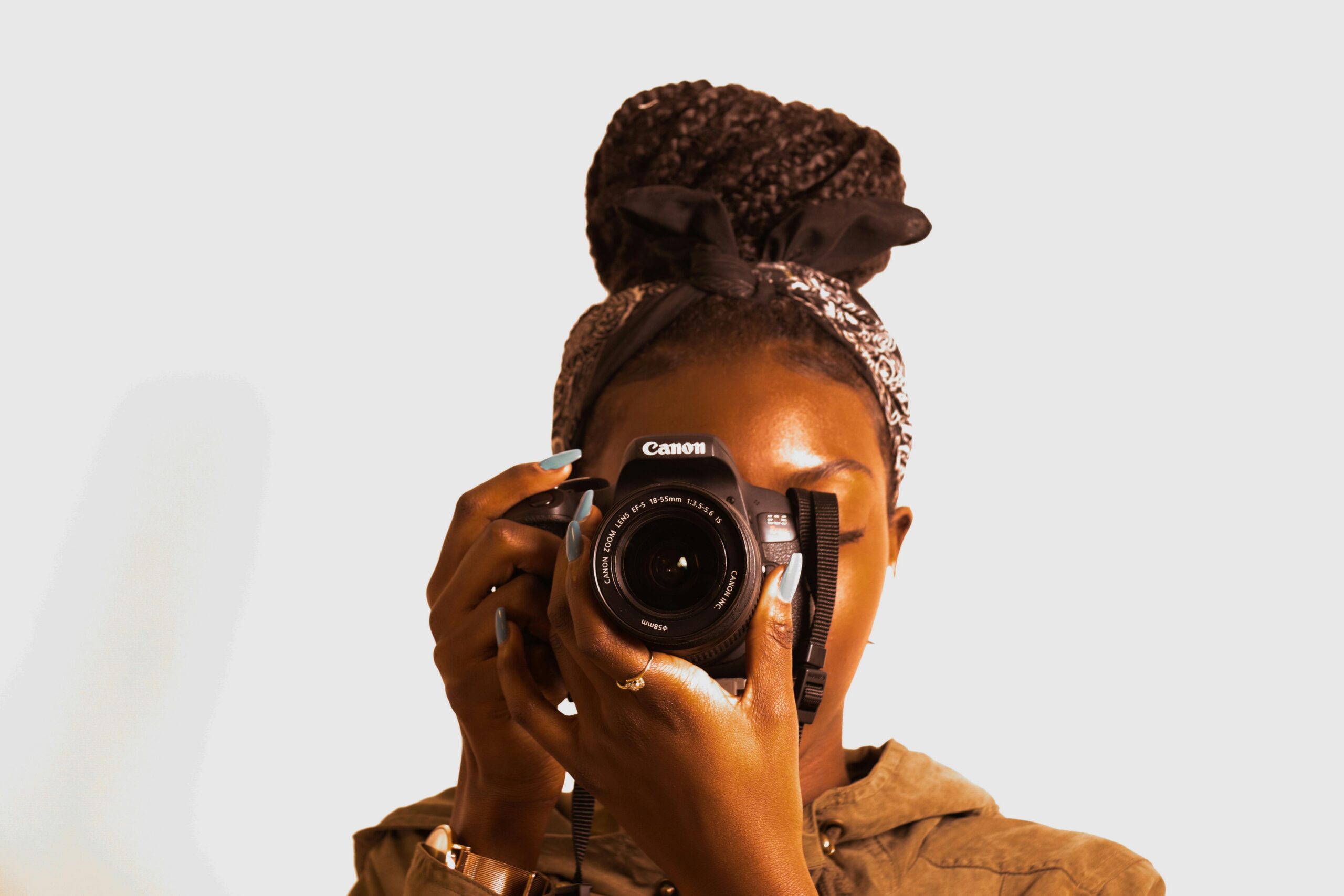 A photographer holding a broken camera
