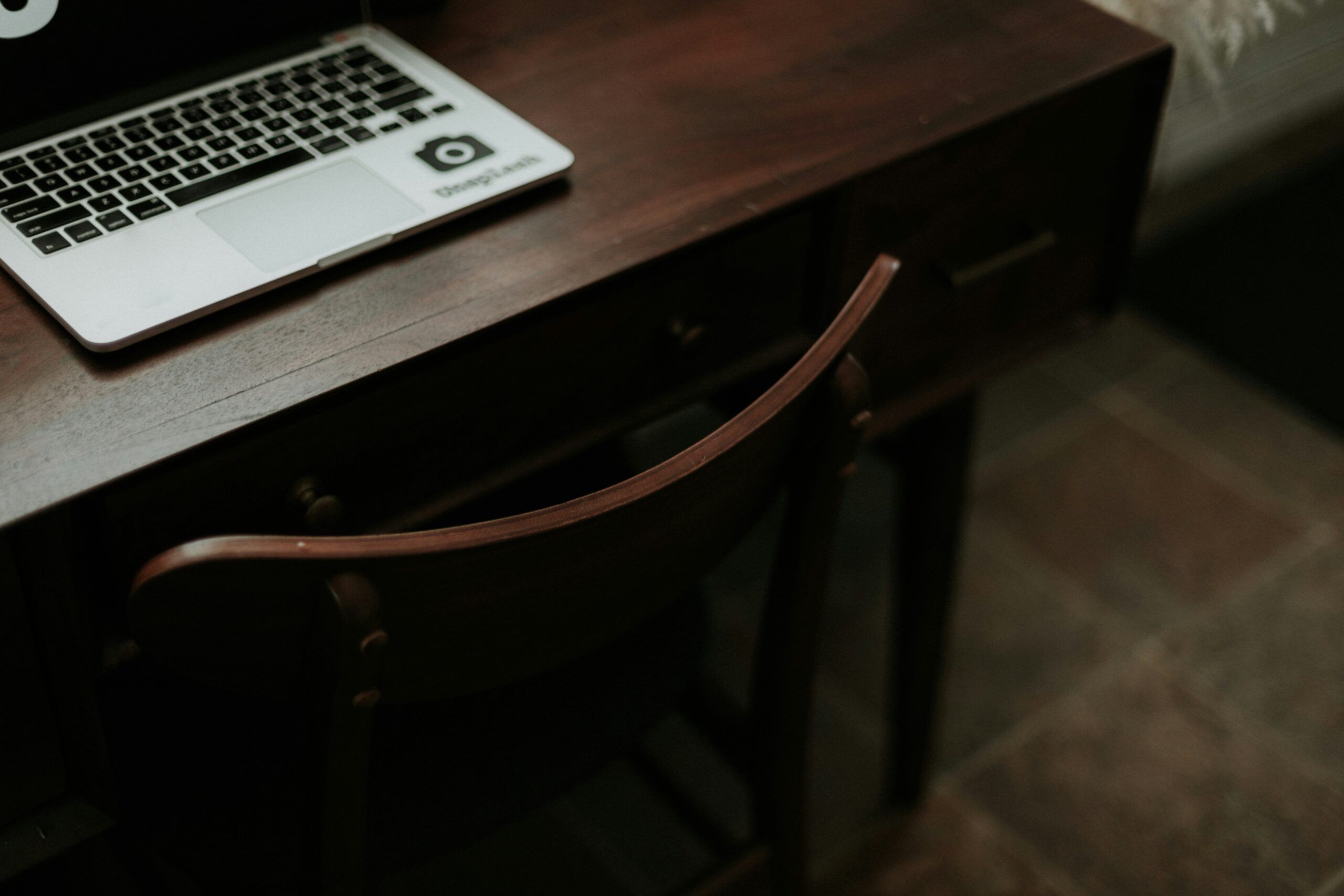 A chaotic desk with papers flying around, symbolizing disorder without tracking tools.